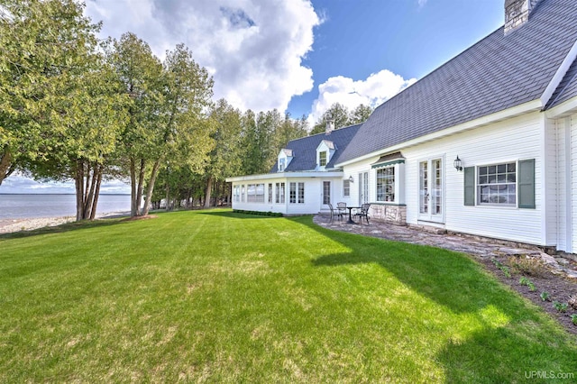 7975 00.25 Rd, Garden, MI 49835 - view of green lawn with a water view and a patio