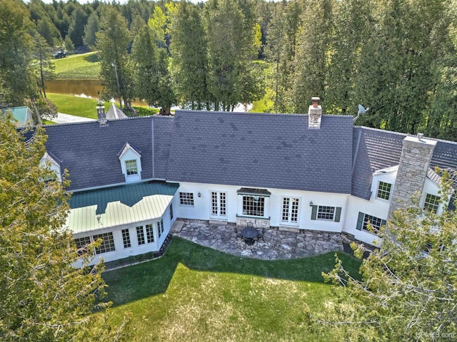 7975 00.25 Rd, Garden, MI 49835 - rear view of property featuring french doors, a chimney, a yard, and a patio area