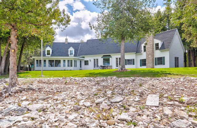 7975 00.25 Rd, Garden, MI 49835 - cape cod house featuring a front lawn and a chimney