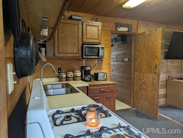 24662 Mud Creek Rd, Mass City, MI 49948 - kitchen with wooden walls, stainless steel microwave, a sink, light countertops, and wood ceiling