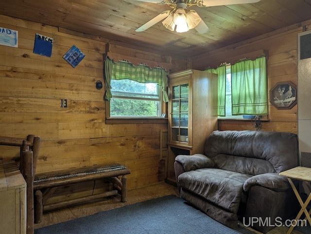 24662 Mud Creek Rd, Mass City, MI 49948 - living area featuring wooden ceiling, ceiling fan, and wood walls