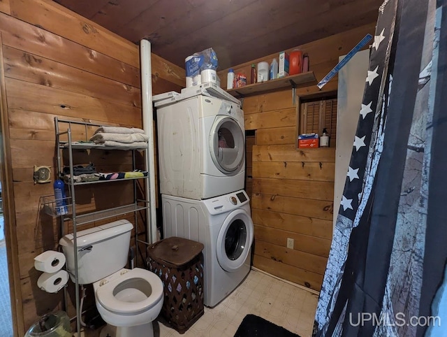 24662 Mud Creek Rd, Mass City, MI 49948 - laundry area featuring estacked washer and dryer, wooden walls, tile patterned floors, and wood ceiling