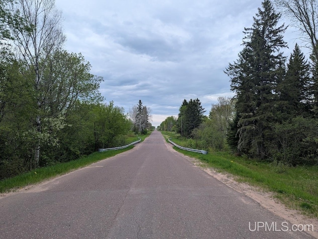 24662 Mud Creek Rd, Mass City, MI 49948 - view of asphalt road featuring a view of trees