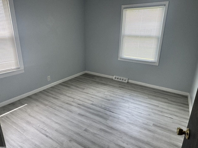 25230 Lehner St, Roseville, MI 48066 - empty room featuring healthy amount of natural light, baseboards, and wood finished floors