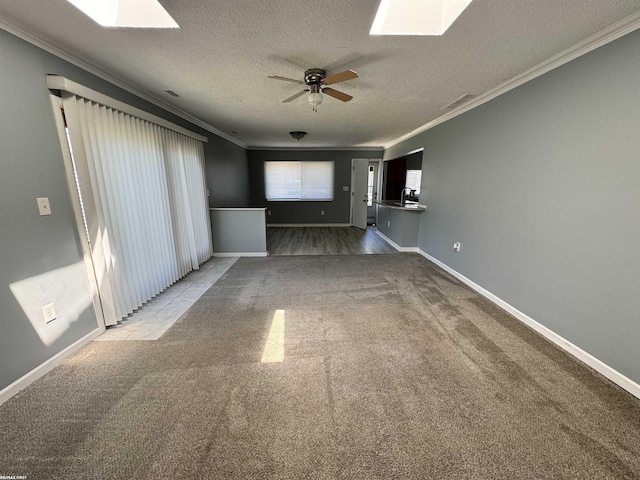 19299 Georgia St, Roseville, MI 48066 - unfurnished living room with carpet flooring, ornamental molding, ceiling fan, a textured ceiling, and a skylight