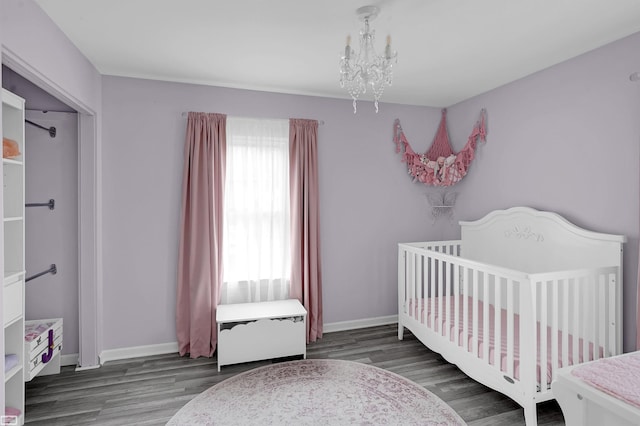 30 Connecticut St, Marysville, MI 48040 - bedroom with a chandelier, wood finished floors, baseboards, and a nursery area
