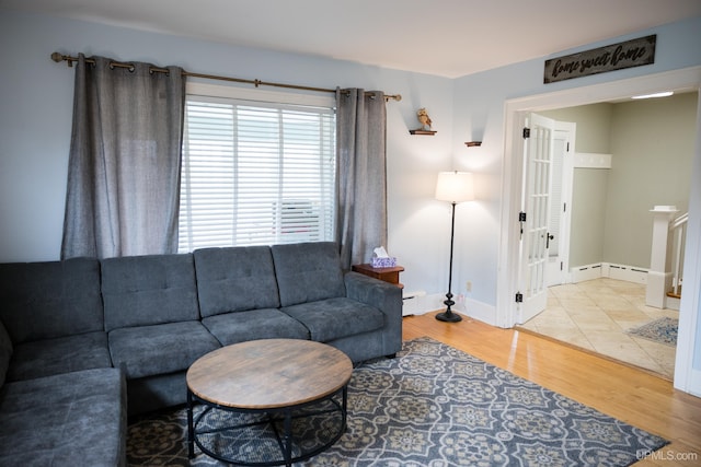 1302 N 3rd St, Ishpeming, MI 49849 - living area with wood finished floors and a baseboard heating unit