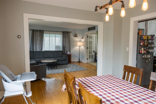 1302 N 3rd St, Ishpeming, MI 49849 - dining space with hardwood / wood-style flooring and a baseboard radiator