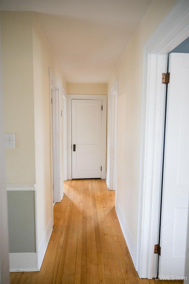 1302 N 3rd St, Ishpeming, MI 49849 - corridor featuring light wood-type flooring and baseboards