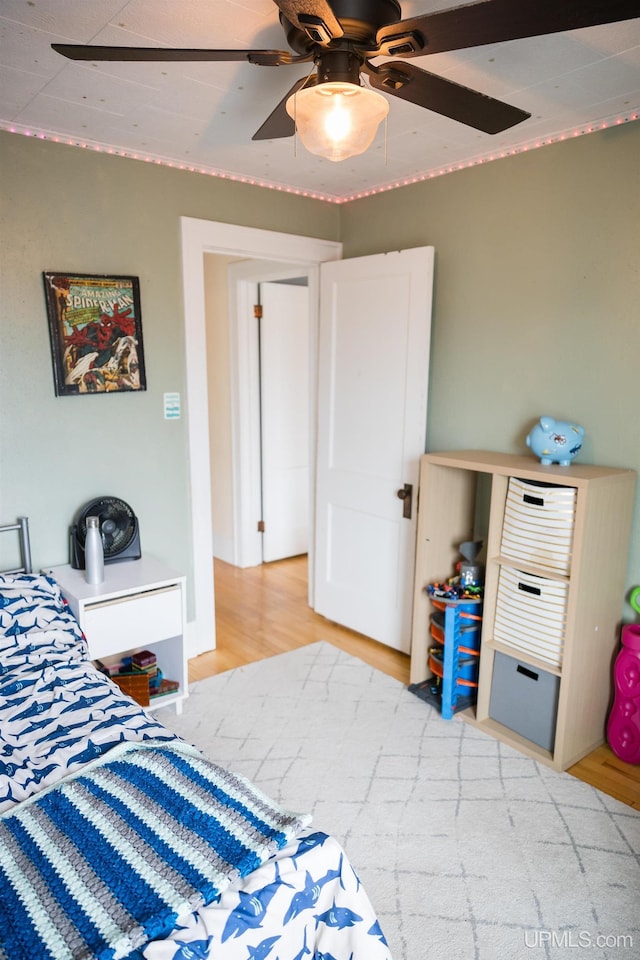 1302 N 3rd St, Ishpeming, MI 49849 - bedroom featuring light wood-style flooring and ceiling fan
