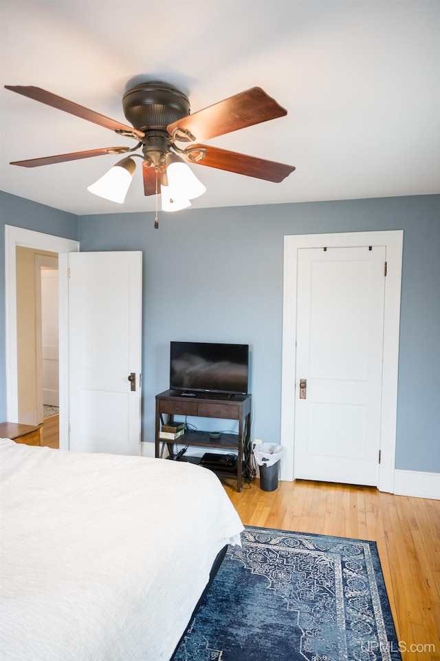 1302 N 3rd St, Ishpeming, MI 49849 - bedroom featuring light wood-style floors, ceiling fan, and baseboards