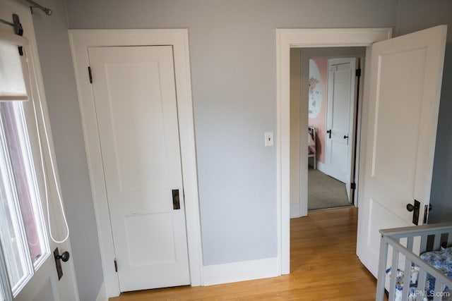 1302 N 3rd St, Ishpeming, MI 49849 - bedroom featuring light wood-type flooring and baseboards