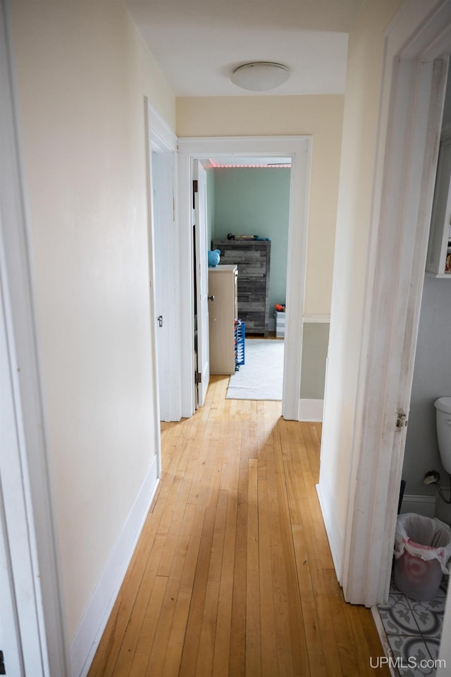 1302 N 3rd St, Ishpeming, MI 49849 - hallway featuring light wood-type flooring and baseboards