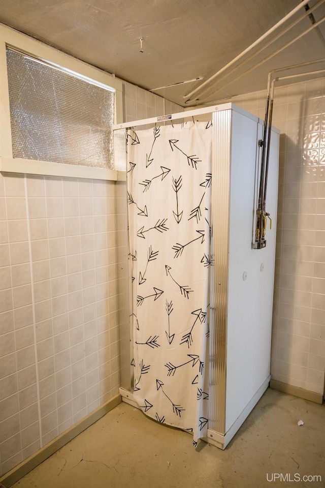 1302 N 3rd St, Ishpeming, MI 49849 - full bathroom featuring concrete flooring, a shower with shower curtain, and baseboards