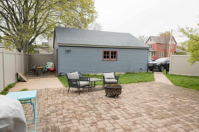 1302 N 3rd St, Ishpeming, MI 49849 - fenced backyard featuring a fire pit and a patio area