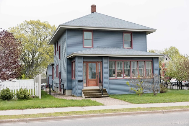 1302 N 3rd St, Ishpeming, MI 49849 - american foursquare style home with entry steps, a chimney, and roof with shingles