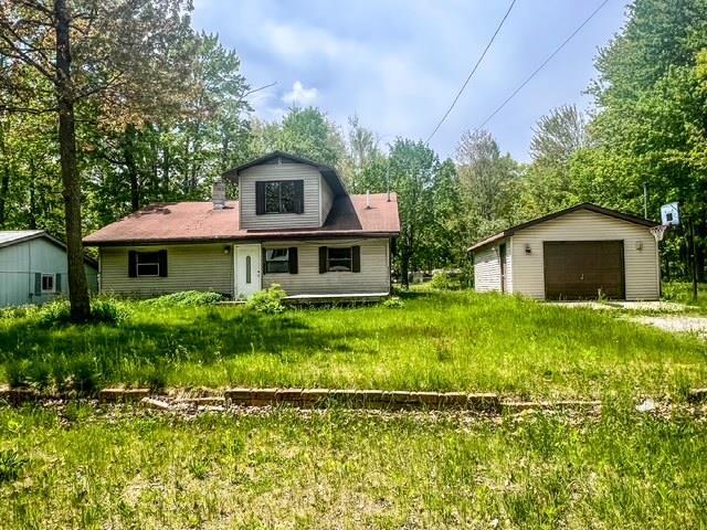 4815 Knollwood Dr, Harrison, MI 48625 - rear view of property featuring a garage and an outdoor structure