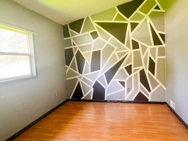 4815 Knollwood Dr, Harrison, MI 48625 - unfurnished room featuring wood finished floors and baseboards