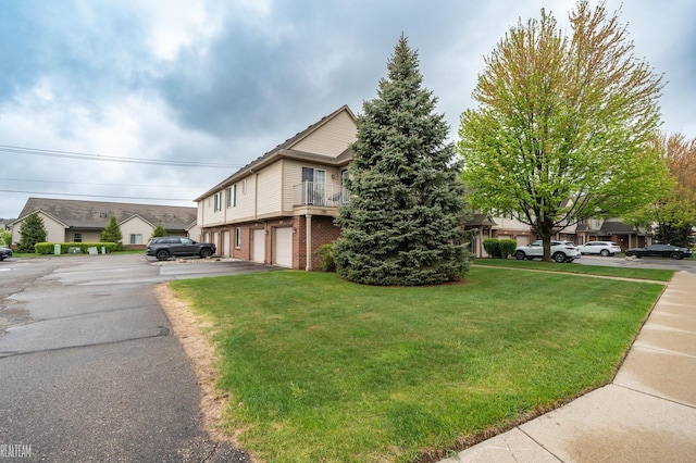 45537 Hidden View Ct, Utica, MI 48315 - view of property exterior with a garage, a lawn, brick siding, and driveway