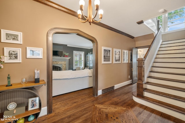 1435 Kensington Ave, Grosse Pointe Park, MI 48230 - staircase featuring wood finished floors, ornamental molding, baseboards, healthy amount of natural light, and a fireplace