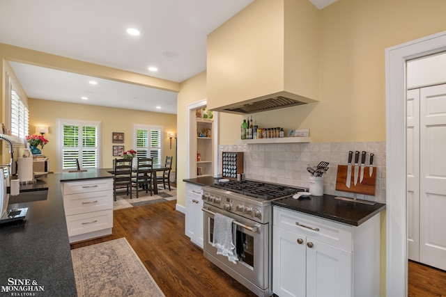 1435 Kensington Ave, Grosse Pointe Park, MI 48230 - kitchen featuring stainless steel range, premium range hood, dark countertops, white cabinetry, and recessed lighting
