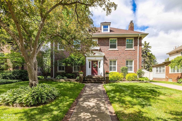 1435 Kensington Ave, Grosse Pointe Park, MI 48230 - view of front facade featuring brick siding, a chimney, and a front yard