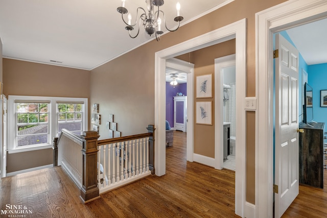 1435 Kensington Ave, Grosse Pointe Park, MI 48230 - corridor featuring an upstairs landing, wood finished floors, a chandelier, ornamental molding, and baseboards