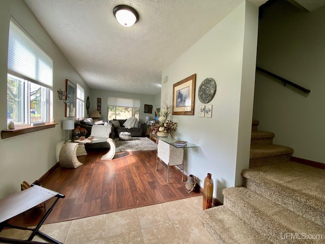 101-103 Juliet St, Marquette, MI 49855 - interior space featuring stairway, a textured ceiling, and baseboards