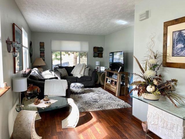 101-103 Juliet St, Marquette, MI 49855 - living area with a textured ceiling and wood finished floors