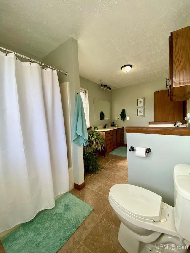 101-103 Juliet St, Marquette, MI 49855 - full bath with toilet, a shower with shower curtain, a textured ceiling, tile patterned flooring, and vanity
