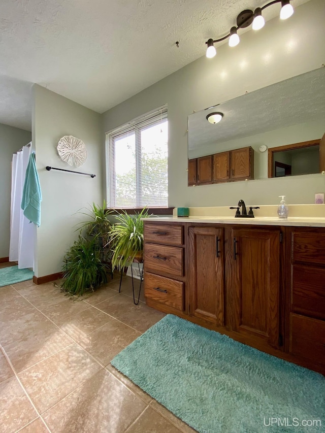 101-103 Juliet St, Marquette, MI 49855 - full bathroom with vanity, tile patterned flooring, and baseboards