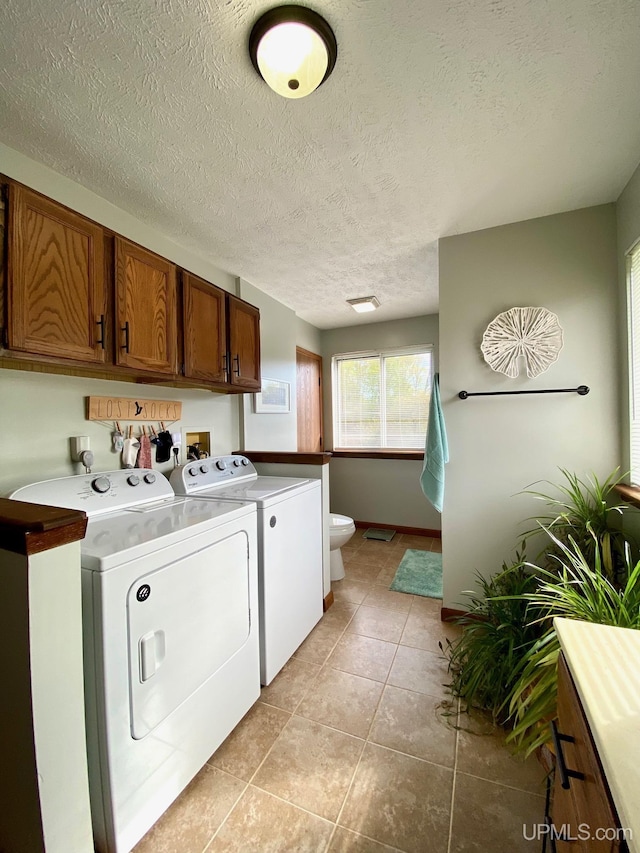 101-103 Juliet St, Marquette, MI 49855 - laundry room with washer and clothes dryer, a textured ceiling, light tile patterned floors, and baseboards