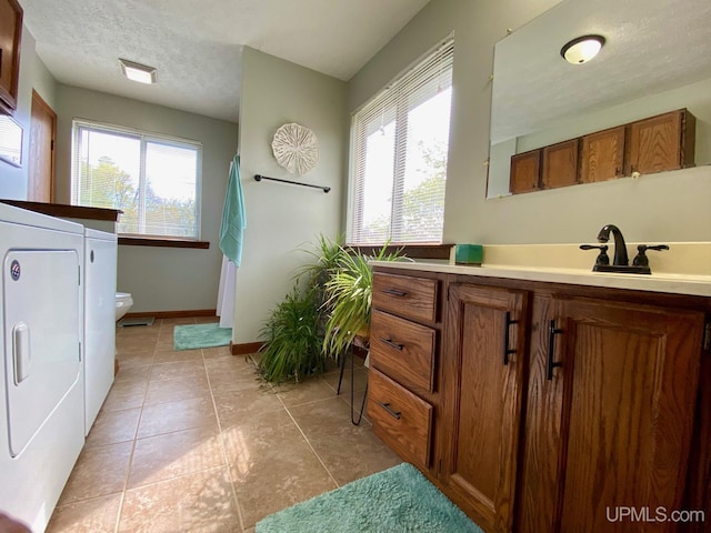 101-103 Juliet St, Marquette, MI 49855 - full bath featuring washer and dryer, plenty of natural light, vanity, baseboards, and a textured ceiling