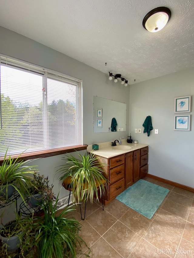 101-103 Juliet St, Marquette, MI 49855 - bathroom featuring vanity, tile patterned floors, a textured ceiling, and baseboards