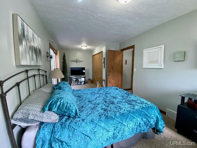 101-103 Juliet St, Marquette, MI 49855 - bedroom featuring carpet flooring, a textured ceiling, and baseboards