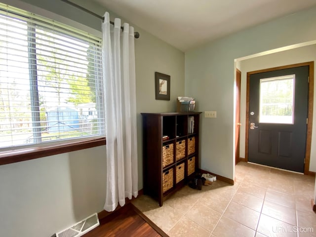101-103 Juliet St, Marquette, MI 49855 - foyer featuring healthy amount of natural light, light tile patterned flooring, and baseboards