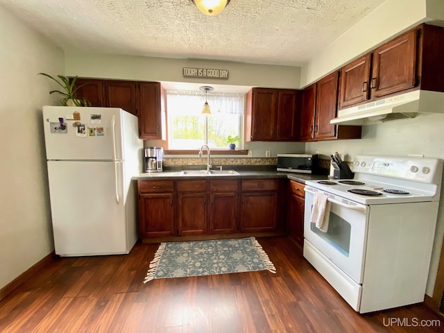 101-103 Juliet St, Marquette, MI 49855 - kitchen featuring white appliances, under cabinet range hood, a sink, dark wood-style floors, and dark countertops