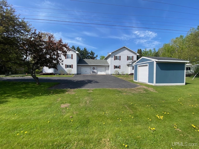 101-103 Juliet St, Marquette, MI 49855 - view of green lawn with a garage and an outdoor structure