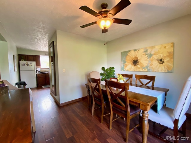 101-103 Juliet St, Marquette, MI 49855 - dining room featuring dark wood-style flooring, a ceiling fan, and baseboards