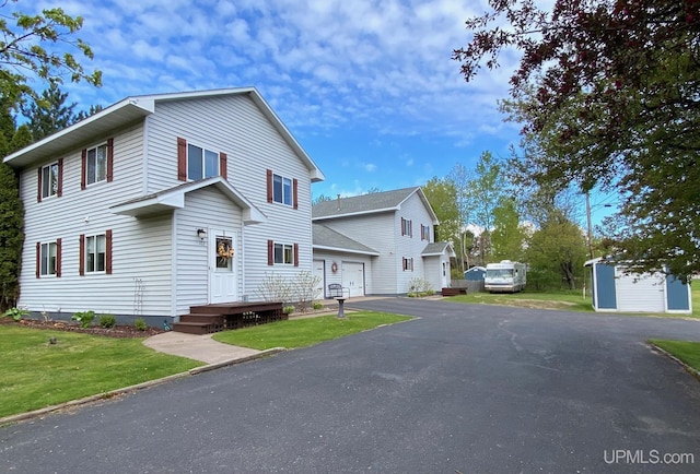 101-103 Juliet St, Marquette, MI 49855 - view of front of home with a front lawn, asphalt driveway, and a detached garage