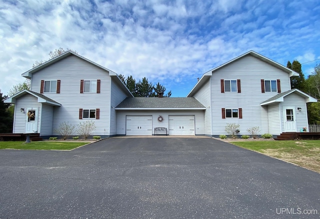 101-103 Juliet St, Marquette, MI 49855 - view of front of property featuring a garage and asphalt driveway