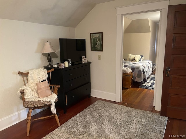 513 Neidhold Ave, Wakefield, MI 49968 - living area with lofted ceiling, dark wood finished floors, and baseboards