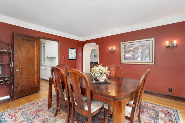 1264 Bedford Rd, Grosse Pointe Park, MI 48230 - dining room with light wood-style floors and arched walkways