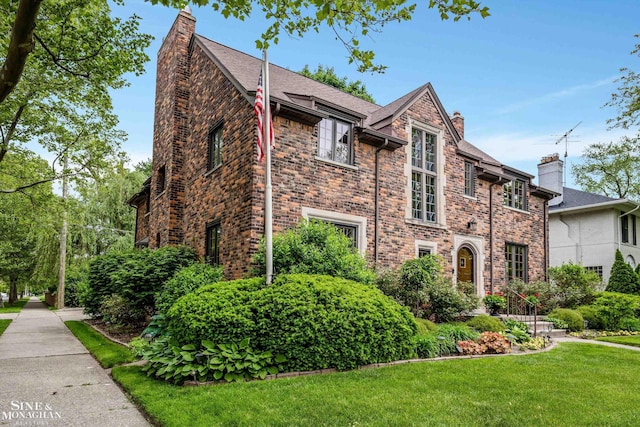 1264 Bedford Rd, Grosse Pointe Park, MI 48230 - view of front facade with a chimney, a front yard, and brick siding