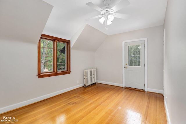 1264 Bedford Rd, Grosse Pointe Park, MI 48230 - additional living space with radiator heating unit, plenty of natural light, wood finished floors, lofted ceiling, and baseboards