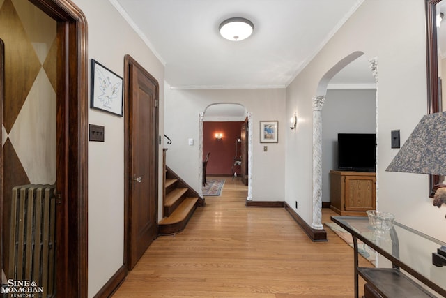1264 Bedford Rd, Grosse Pointe Park, MI 48230 - hall featuring arched walkways, radiator heating unit, light wood-style floors, crown molding, and baseboards