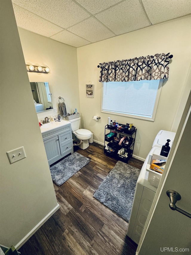 200 Marquette St, Negaunee, MI 49866 - bathroom featuring a paneled ceiling, vanity, wood finished floors, toilet, and baseboards