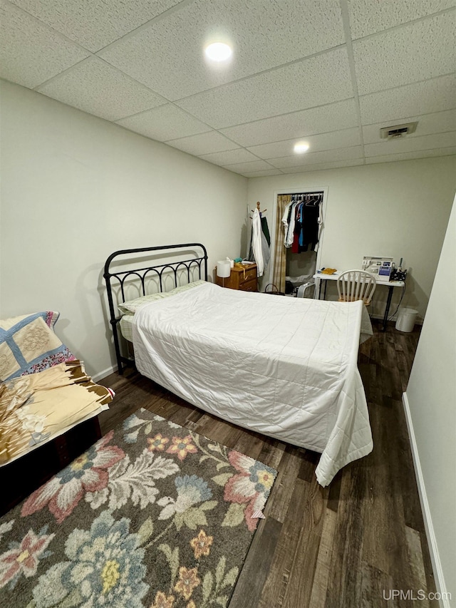 200 Marquette St, Negaunee, MI 49866 - bedroom featuring wood finished floors, a paneled ceiling, baseboards, and recessed lighting