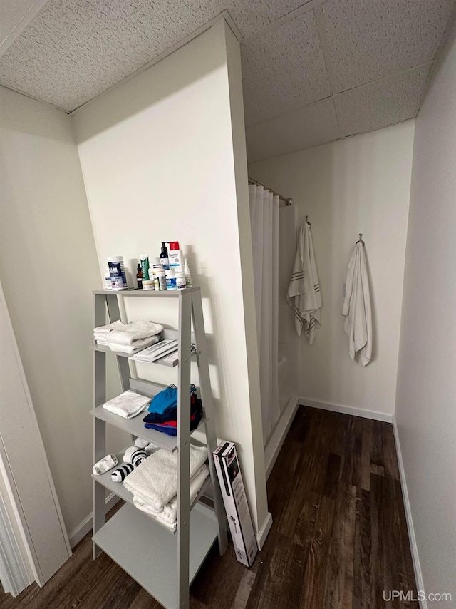 200 Marquette St, Negaunee, MI 49866 - full bathroom featuring wood finished floors, a shower with curtain, and baseboards
