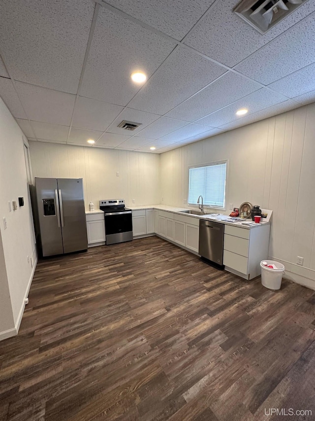 200 Marquette St, Negaunee, MI 49866 - kitchen featuring appliances with stainless steel finishes, a sink, dark wood finished floors, light countertops, and a paneled ceiling